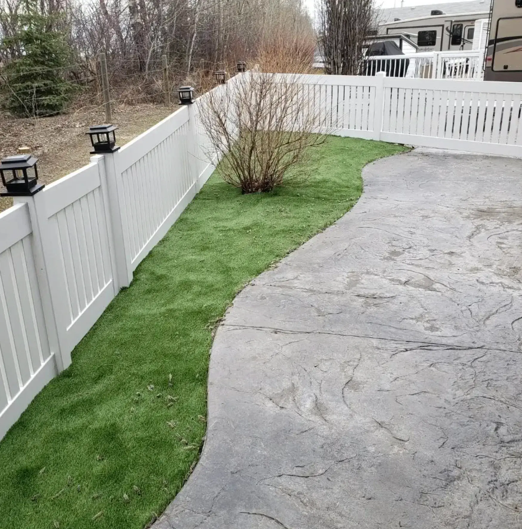 Stamped Concrete & Grass - After renovation by Epic Landscape Services in Red Deer