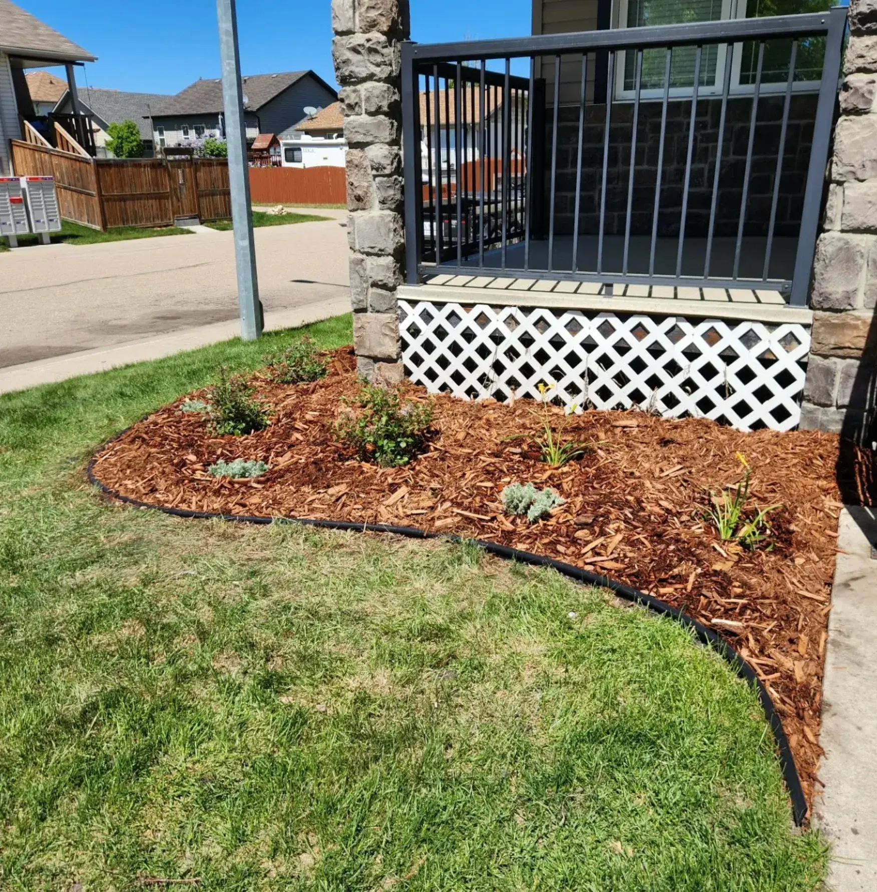 Curved Garden Bed Design - After renovation by Epic Landscape Services in Red Deer